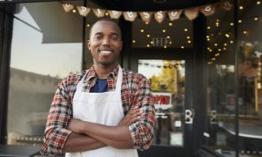 Man standing in front of his small business