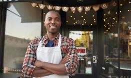 Man standing in front of small business