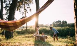 A couple playing with their child and dog