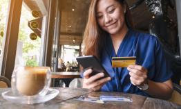 Woman entering credit card information on phone.