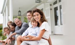 A family on the front porch of their home.