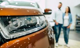 A couple looking at a new car.